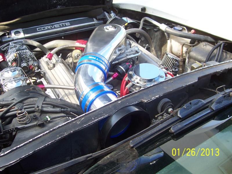 Corvette engine bay with chrome intake and visible engine components