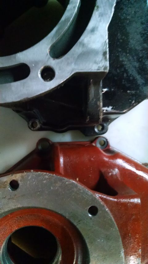 1985 Jeep CJ7 - Two engine parts are shown in detail, one painted black and the other red, with visible mounting holes.