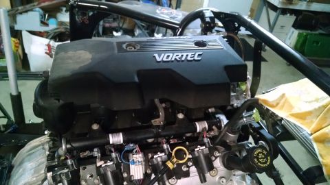 1985 Jeep CJ7 - Close-up of a Vortec engine, likely a V8, with visible fuel injectors and ignition coils.