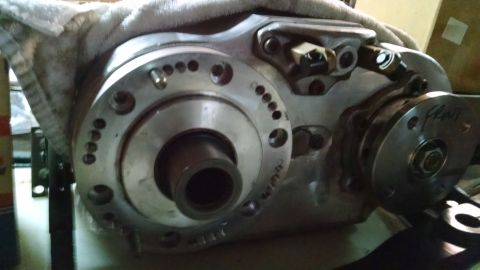 1985 Jeep CJ7 - A close-up view of a vehicle's transfer case, showing mechanical components and a handwritten label.