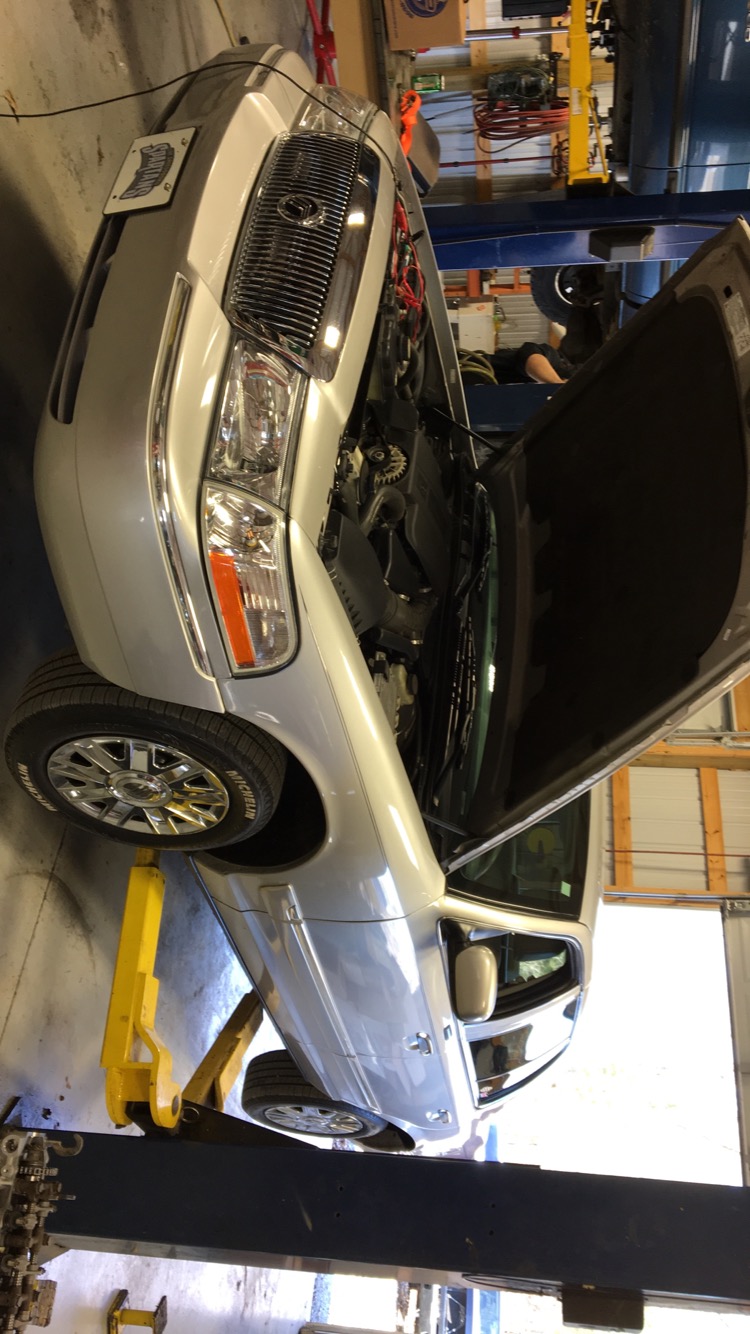 Mercury Grand Marquis on a lift with hood open