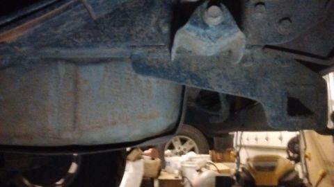 1985 Ford Bronco - A view of the vehicle's undercarriage, focusing on the fuel tank and suspension system.