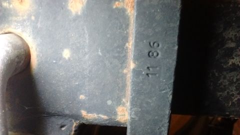 1985 Ford Bronco - A metal part shows a stamped date of 11 86, indicating it was manufactured in November 1986.
