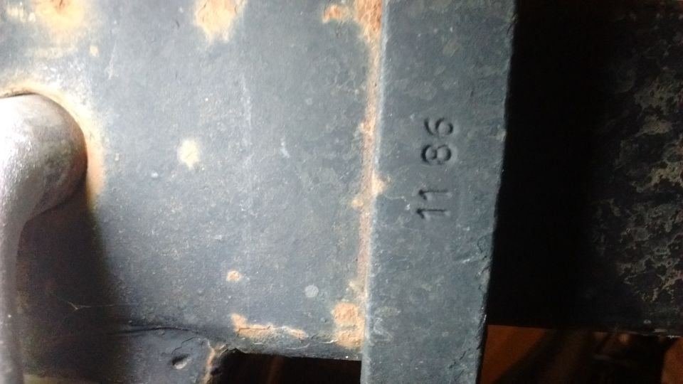 close-up of metal casting with '11 86' stamped on it