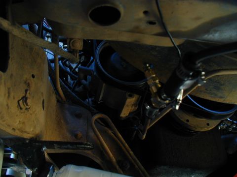1988 Ford Bronco - Close-up view of engine bay components, including hoses and a brass fitting.