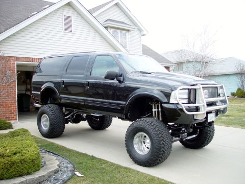 2001 Ford Excursion - This modified Ford Excursion features a significant lift kit and large off-road tires.