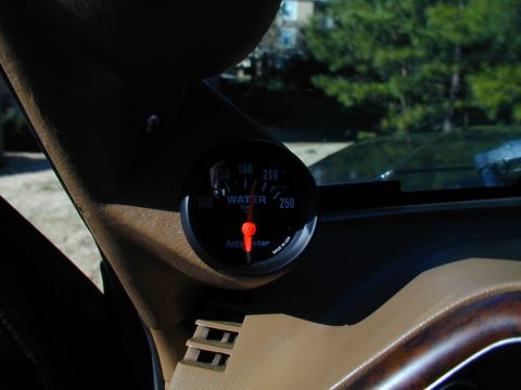 1988 Ford Bronco - A close-up of an aftermarket water temperature gauge installed in the vehicle's interior.