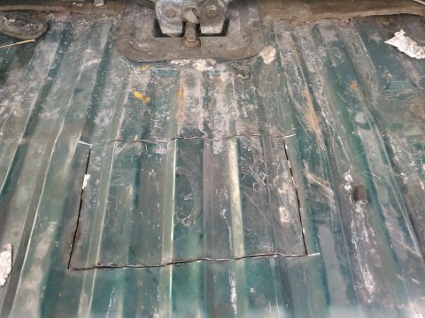 1996 Ford Bronco - i looked at the floor for the line of spot welds. this is where a crossmember is to hold the floor. i started cutting alittl away form the…