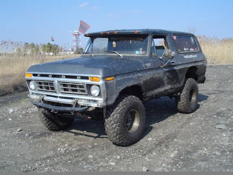 1979 Ford Bronco - This lifted Ford Bronco is covered in mud, suggesting it has seen some off-road action.