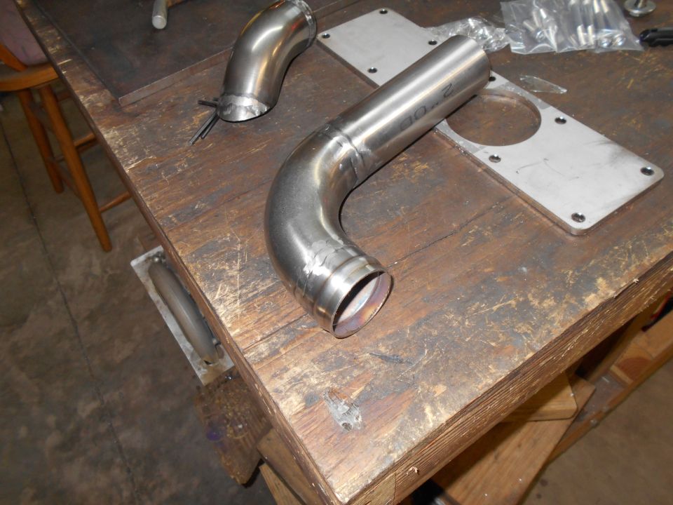 Exhaust pipe and mounting plate on workbench