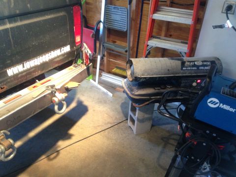1979 Ford Bronco - A trailer hitch is attached to the rear of a truck, with a portable heater and welding equipment nearby.