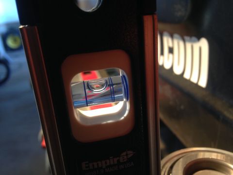 1979 Ford Bronco - A close-up of a level tool shows the bubble, with 'SUPERMOTORS' text visible in the background.