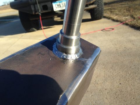 1979 Ford Bronco - Close-up of a welded metal component attached to the rear bumper of a vehicle, with a license plate visible.