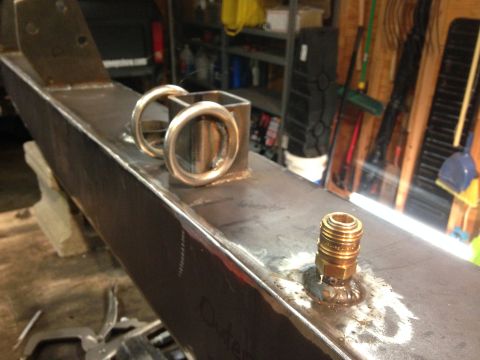 1979 Ford Bronco - Custom fabricated steel bumper section with D-rings and a brass fitting, likely for off-road use.