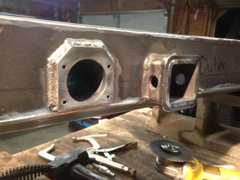 1979 Ford Bronco - Close-up of a custom-welded steel bumper section, showing fabrication details and tools nearby.
