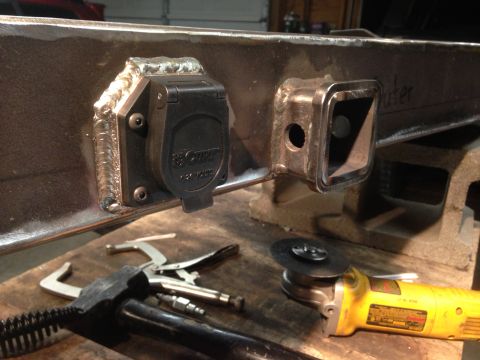 1979 Ford Bronco - A custom-fabricated trailer hitch receiver and 7-pin connector are shown, with tools nearby.