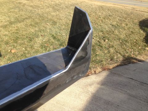 1979 Ford Bronco - A custom-fabricated steel bumper is shown outdoors, resting on concrete and grass.