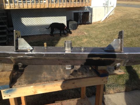 1979 Ford Bronco - A custom fabricated metal bumper is shown resting on sawhorses outdoors.