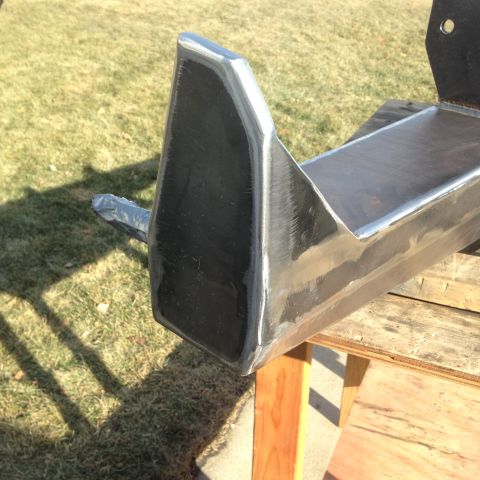 1979 Ford Bronco - A close-up view of a custom-fabricated rear bumper corner, showing welded seams and a raw metal finish.