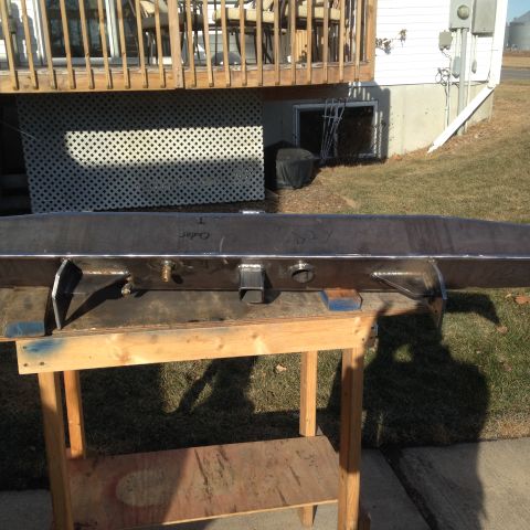 1979 Ford Bronco - A fabricated steel bumper sits on sawhorses outside a house, with some handwritten markings visible.