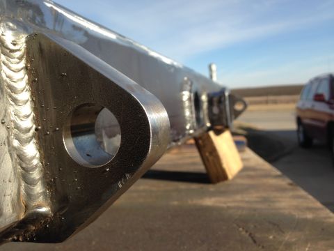 1979 Ford Bronco - Close-up of a fabricated metal part, likely a bumper component, with visible welds and mounting holes.