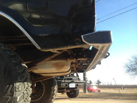 1979 Ford Bronco - Custom rear bumper fabrication on a black 1979 Ford Bronco, showing the underside and suspension components.