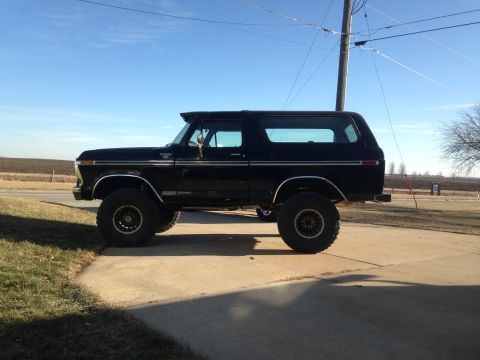 1979 Ford Bronco - This lifted 1978 Ford Bronco is shown from the side, large tires and aftermarket wheels.