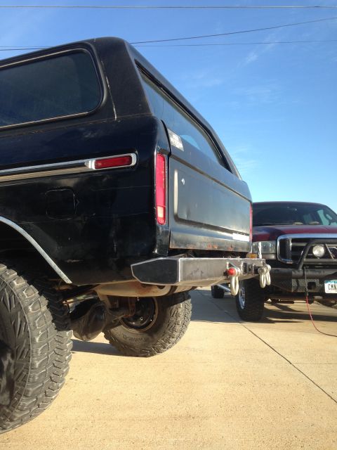 1979 Ford Bronco - Rear view of a black 1979 Ford Bronco a custom fabricated bumper, with another truck visible behind it.