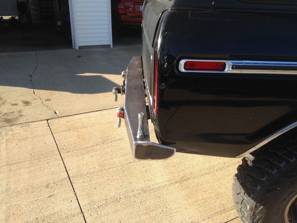 Black SUV rear with custom metal bumper and red taillight