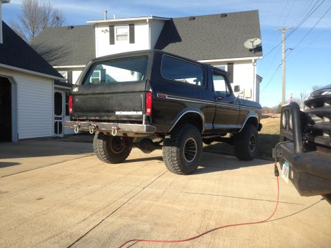 1979 Ford Bronco - Black 1979 Ford Bronco features a custom rear bumper with multiple tow hooks, parked next to another vehicle.