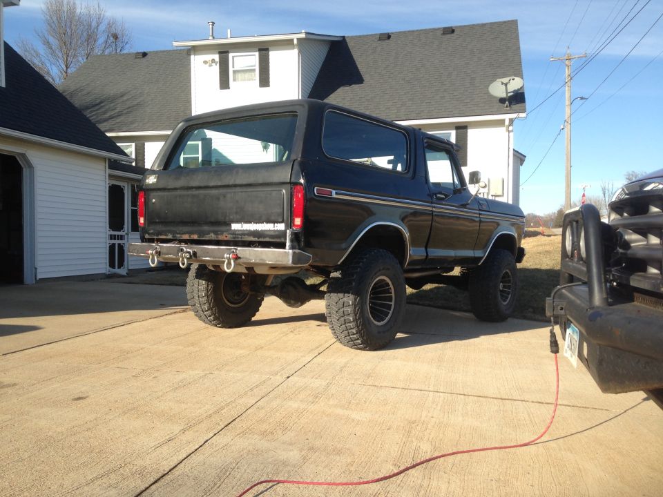 Rear view of black 1979 Ford Bronco with custom bumper and tow hooks