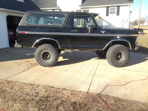 1979 Ford Bronco - This black SUV, likely a 1978 model, is shown from the side with chrome trim and off-road tires.