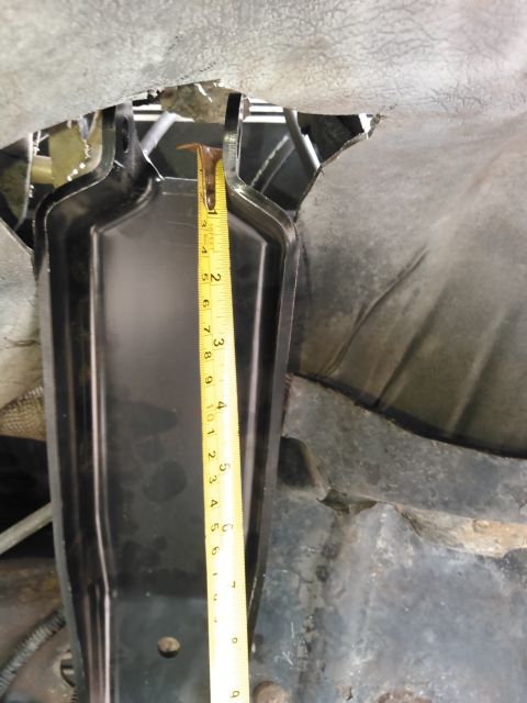 1996 Ford Bronco - A yellow measuring tape is placed against a black metal bracket attached to the underside of a vehicle. The tape shows measurements in inch…