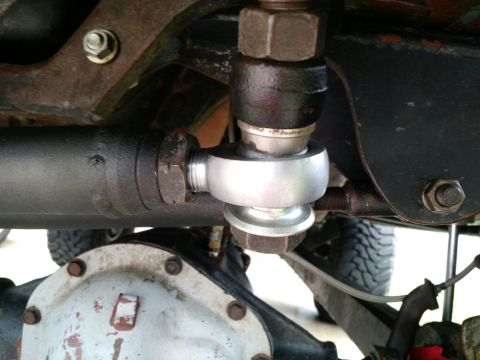 1992 Ford Bronco - Close-up view of the steering linkage components on a 1992 Ford Bronco, showing a tie rod end connecting to a steering arm and the differen…