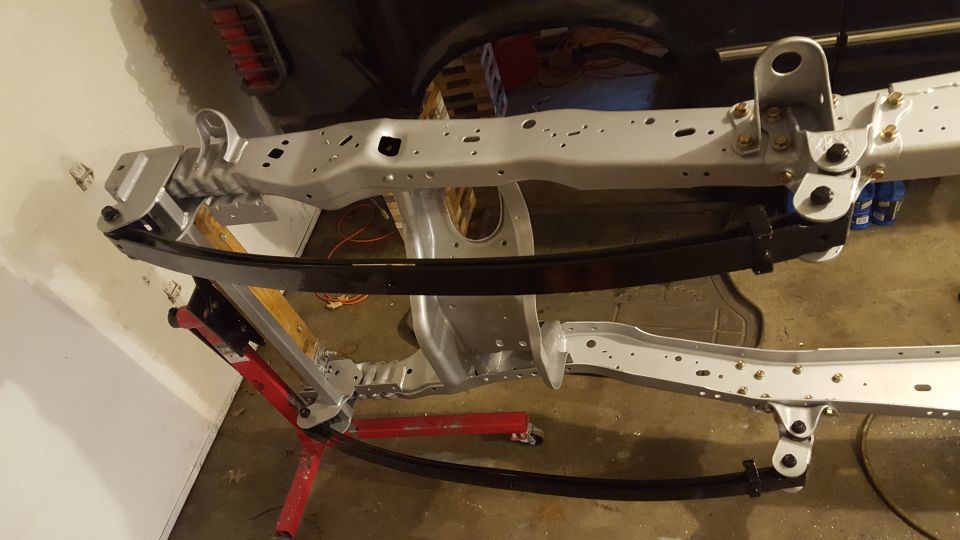 Vehicle frame with leaf springs on jack stands