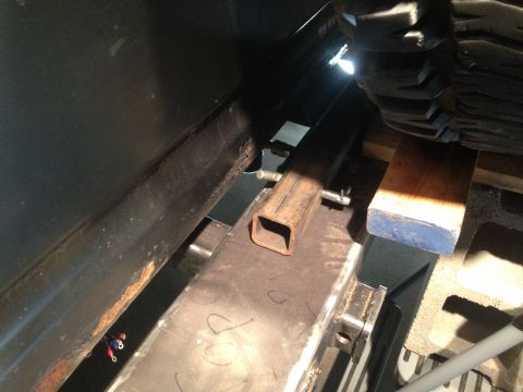 1979 Ford Bronco - A close-up view shows metal framing and support structures, possibly part of a vehicle modification or repair. A section of black, rusted m…
