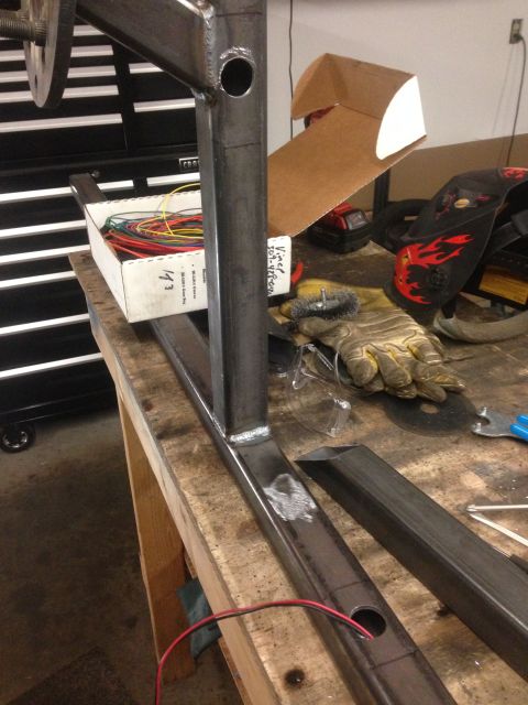 1979 Ford Bronco - A close-up view of metal fabrication work on a workbench. Various tools and materials, including a box of wires, welding gloves, and a weld…