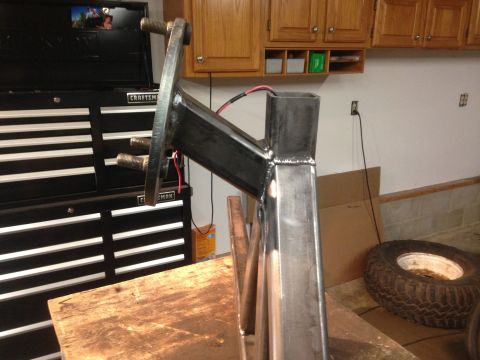 1979 Ford Bronco - A close-up view of a custom-fabricated metal bracket with large bolts, likely part of a vehicle modification. The bracket is welded and app…
