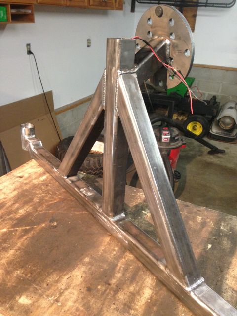 1979 Ford Bronco - A custom-fabricated steel trailer hitch assembly is shown mounted on a workbench. The assembly features a central vertical tube with angled…