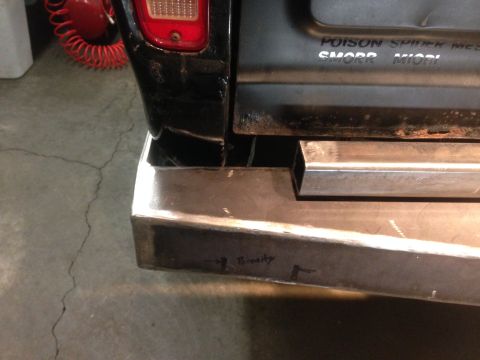 1979 Ford Bronco - A close-up rear view shows a custom metal bumper on a black vehicle. The bumper has a square metal tube welded to the top, and the word "Po…