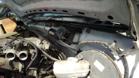 1994 Ford Bronco - Under the hood of a 1994 Ford Bronco, the engine bay reveals various components including the throttle body, brake booster, and windshield…