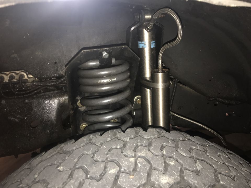 Rear suspension of a vehicle with coil spring and shock absorber.