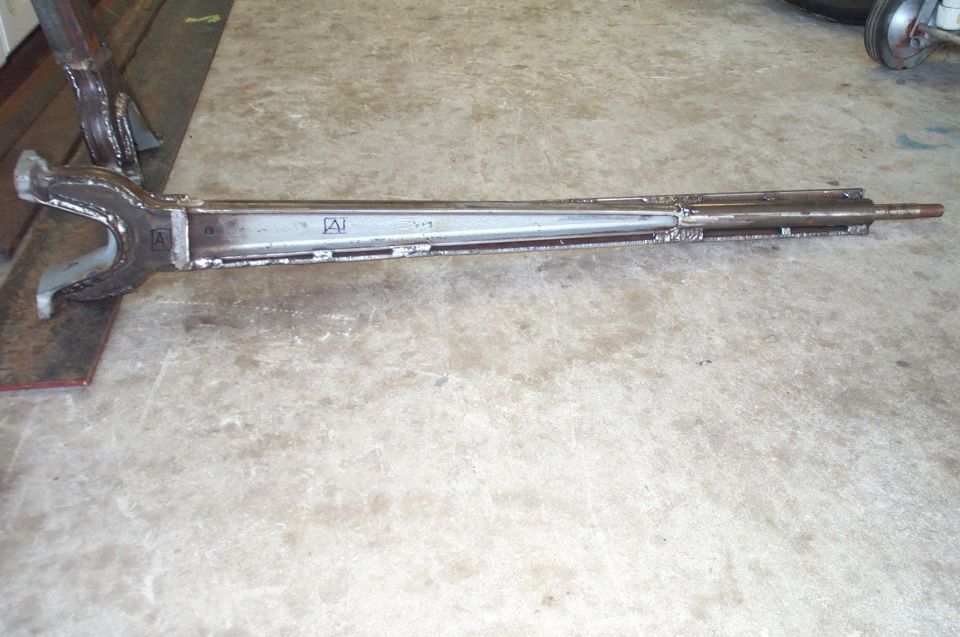 Heavy-duty metal tool with "A" logo on concrete floor