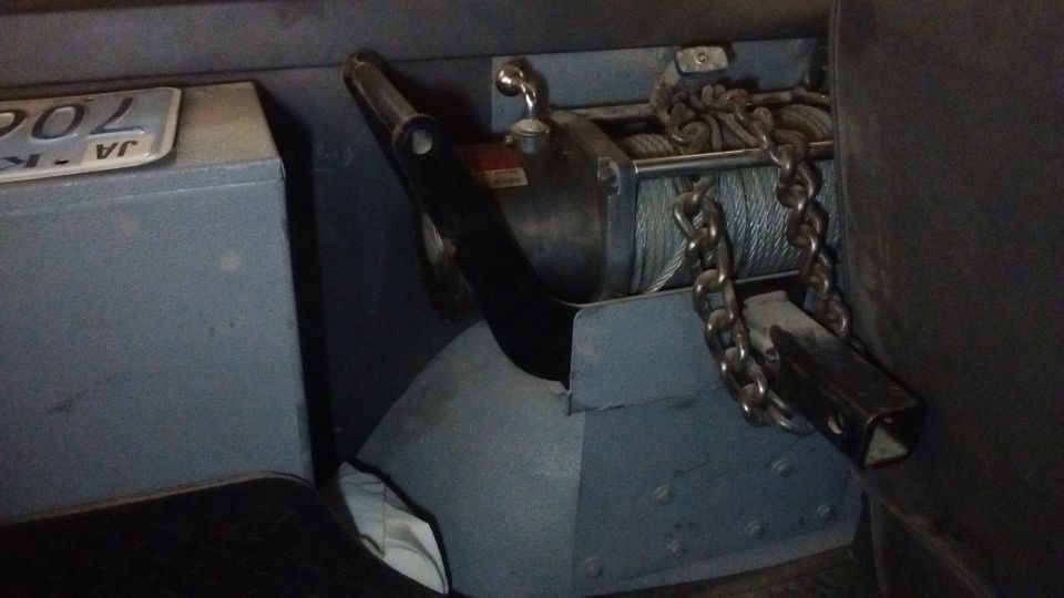 winch with cable and chain, license plate visible