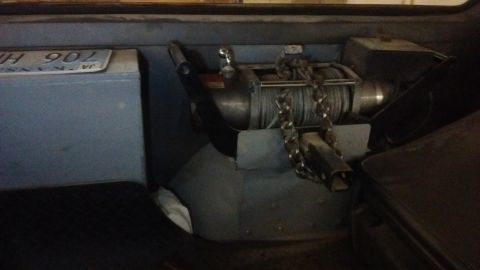 1985 Ford Bronco - A winch and license plate are visible inside a vehicle's cargo area.