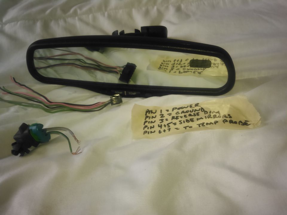 This is a rear view mirror that came on some GM vehicles. it has a compass and temperature display and is auto dimming.  they are avalible at junkyards and on ebay for cheap. i think i paid $35 for the mirror with sensor on ebay
