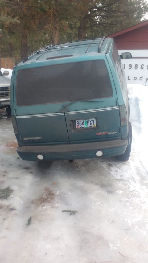 1995 GMC Safari - 1995 GMC Safari van parked in snow, rear view showing license plate and 'Safari' badging.