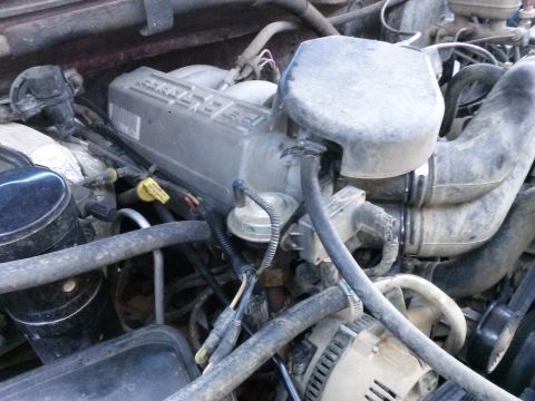 1996 Ford Bronco - Close-up view of the engine bay, showing the air intake system and engine cover.
