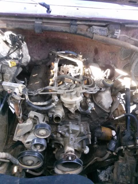 1996 Ford Bronco - Close-up view of an engine bay, showing various components and wiring.