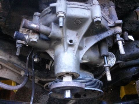 1996 Ford Bronco - This is a close-up view of a vehicle's water pump assembly, showing its various components and connections.